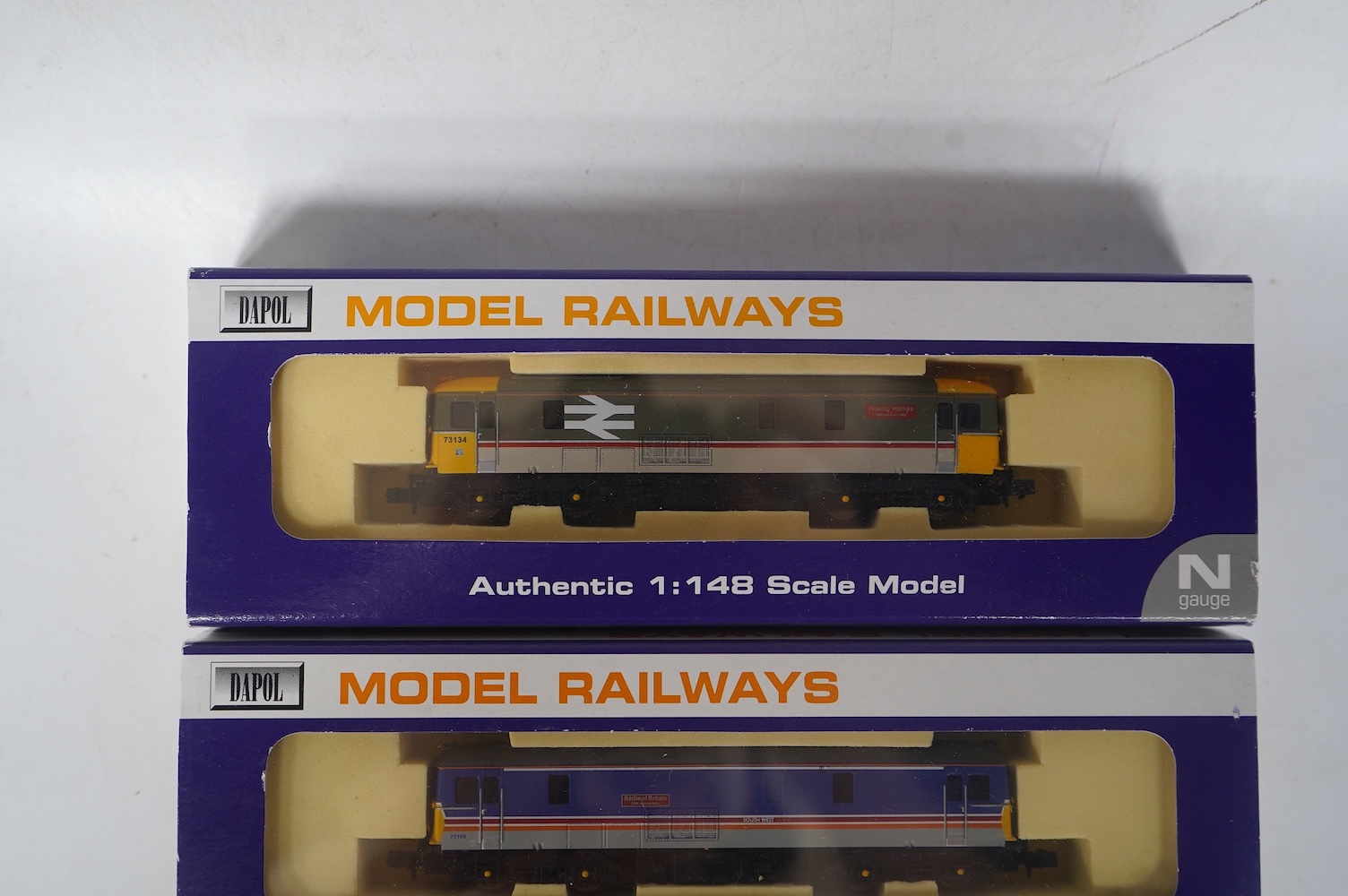 Three boxed Dapol N gauge railway Class 73 electro-diesel locomotives; 73109 Battle of Britain (ND006), 73114 Stewarts Lane (ND-021a) and 73134 Woking Homes (ND-007). Condition - good.